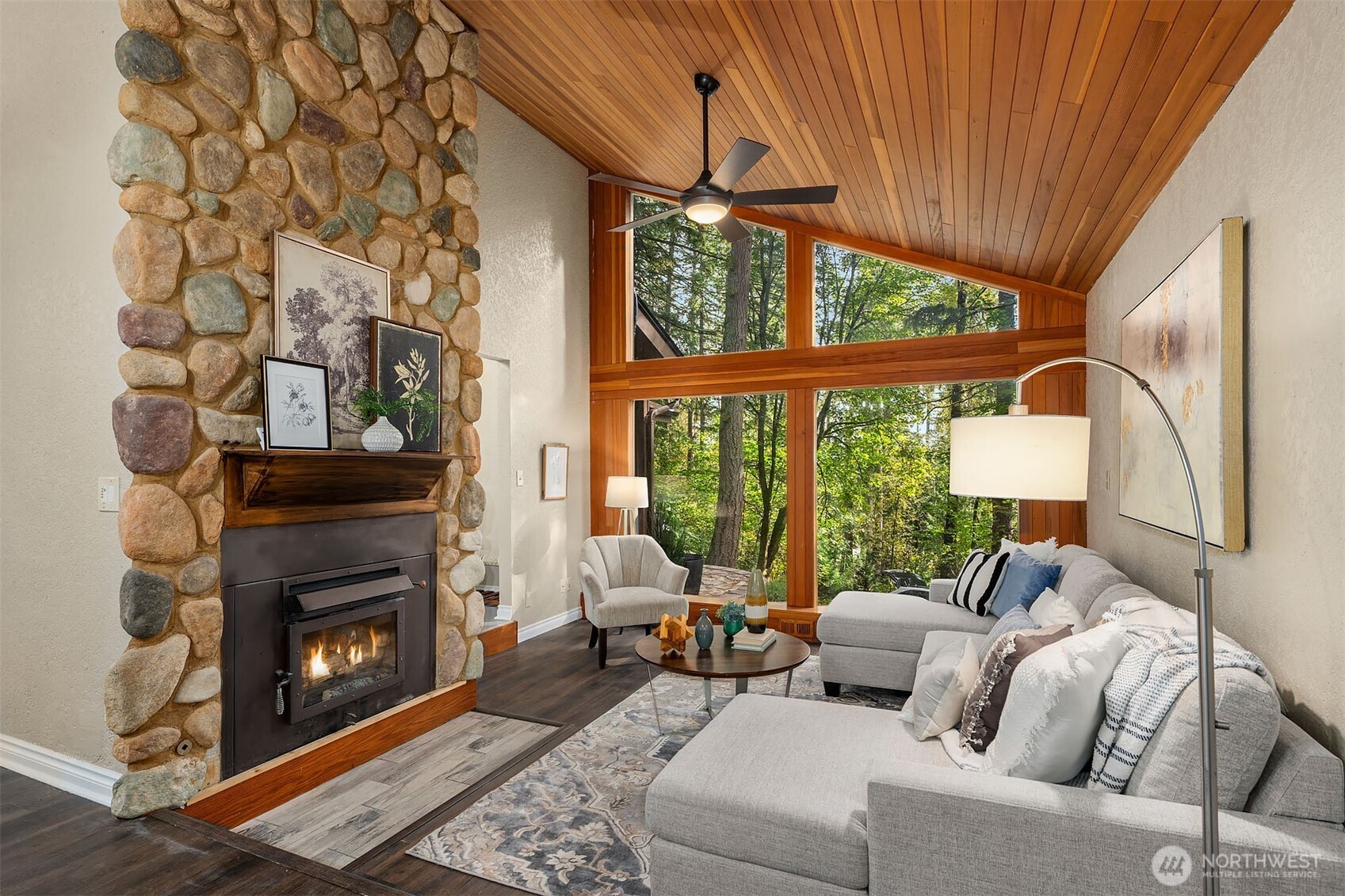 25156 Southeast 158th Street Issaquah, WA 98027 - Photo 3 of 30 a living room with furniture a fireplace and a floor to ceiling window