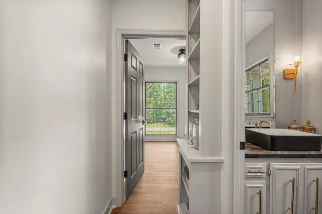 a bathroom with a sink vanity granite tub and shower