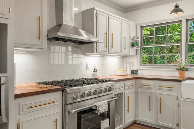 a kitchen with granite countertop a sink stainless steel appliances and cabinets