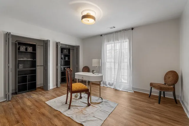 a work room with furniture and wooden floor