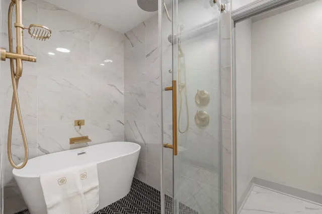 a bathroom with a bathtub and shower