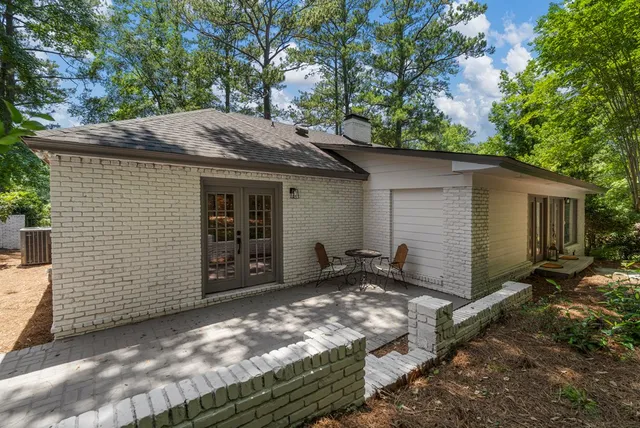 a view of a backyard with sitting area furniture and garden