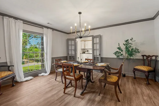 a view of a dining room with furniture window and wooden floor