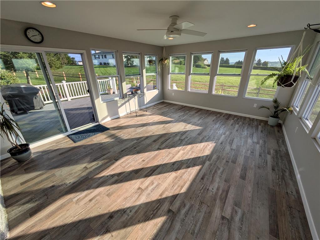 3285 Cherryville Road Northampton, PA 18067 - Photo 41 of 51 Sunlight streams across the wood floors of a spacious sunroom lined with windows.