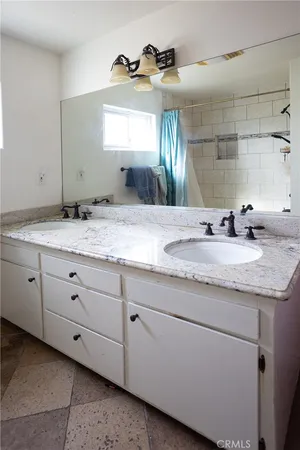 a view of a small white house next to a yard