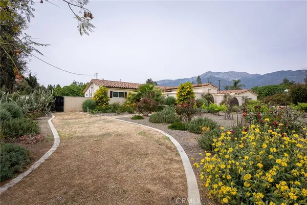 an aerial view of a house with a yard and potted plants