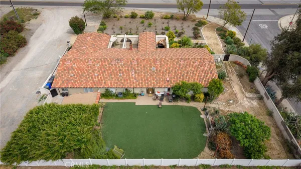 a view of a house with a yard and potted plants