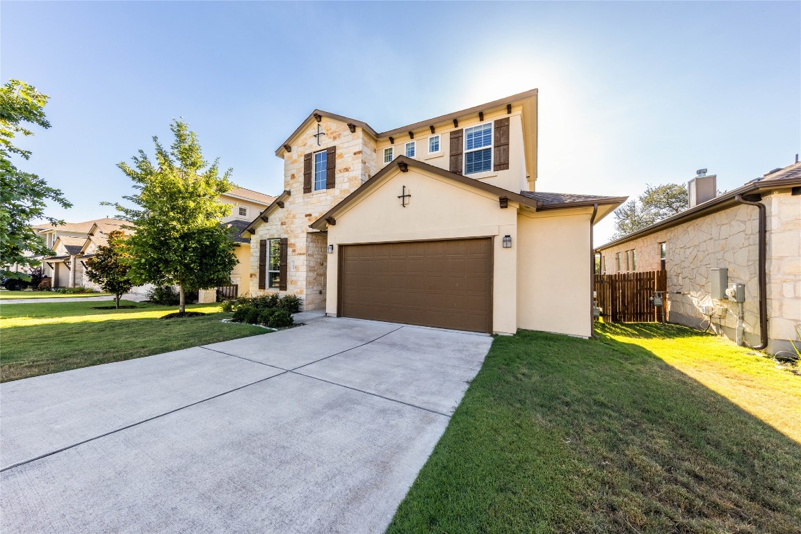 a front view of a house with a yard and garage