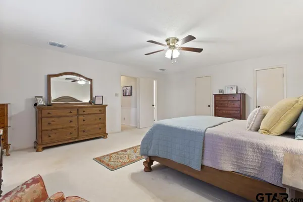 a bedroom with a bed and dresser