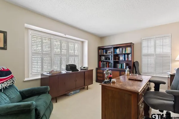 a livingroom with workspace and a window
