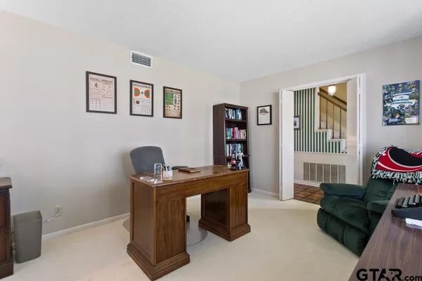 a view of a workspace with furniture and a window