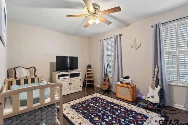 a bedroom with furniture and a flat screen tv
