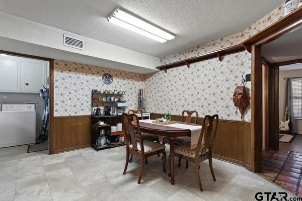 a view of a dining room with furniture and chandelier