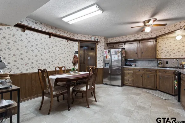 a kitchen with a table and chairs in it