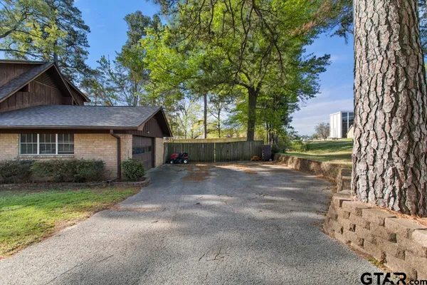 a front view of a house with a garden and yard