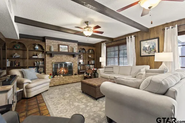 a living room with fireplace furniture and a chandelier