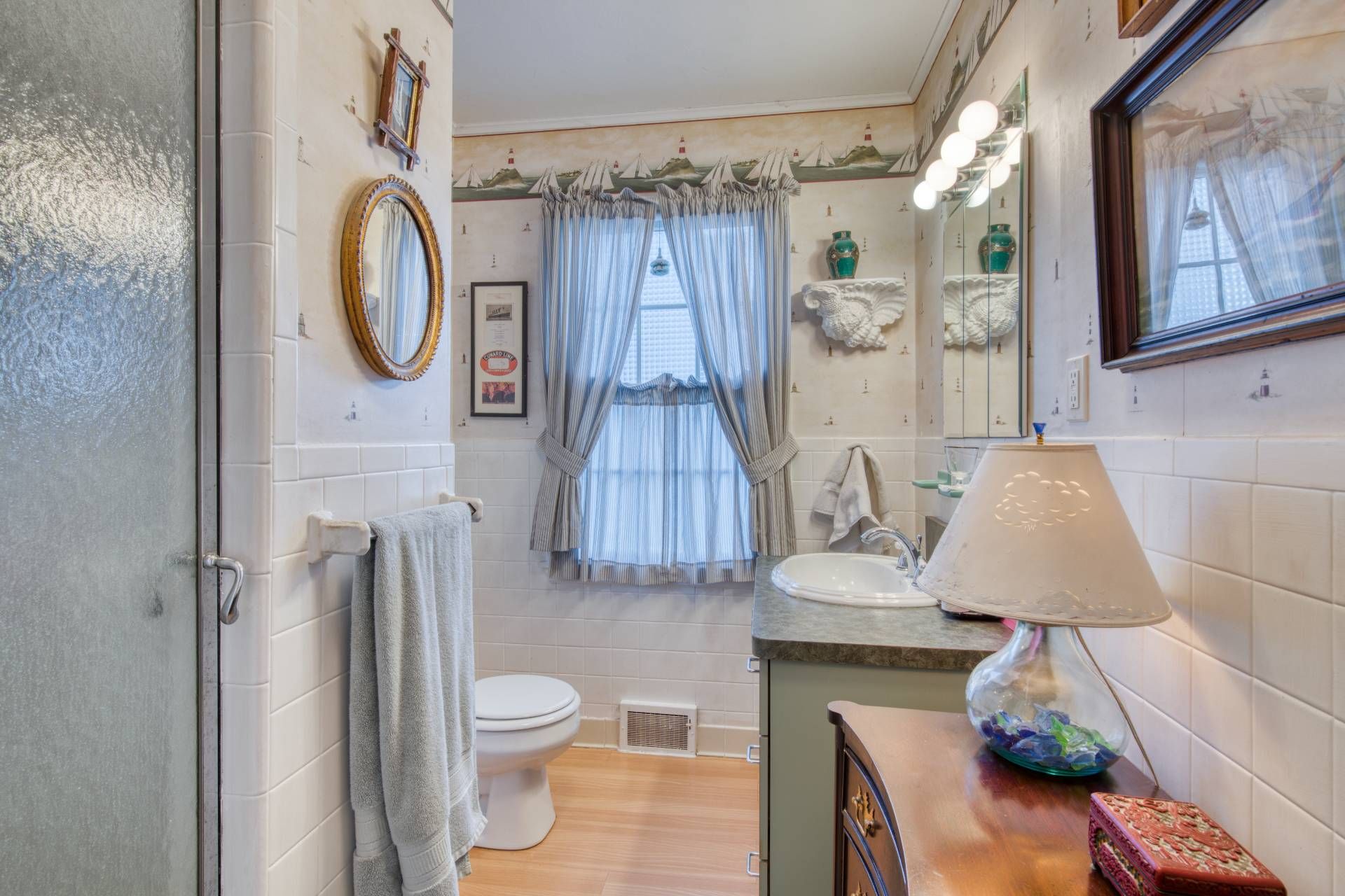 335 Sound View Road Orient, NY 11957 - Photo 21 of 22 a bathroom with a toilet a sink and a shower curtain