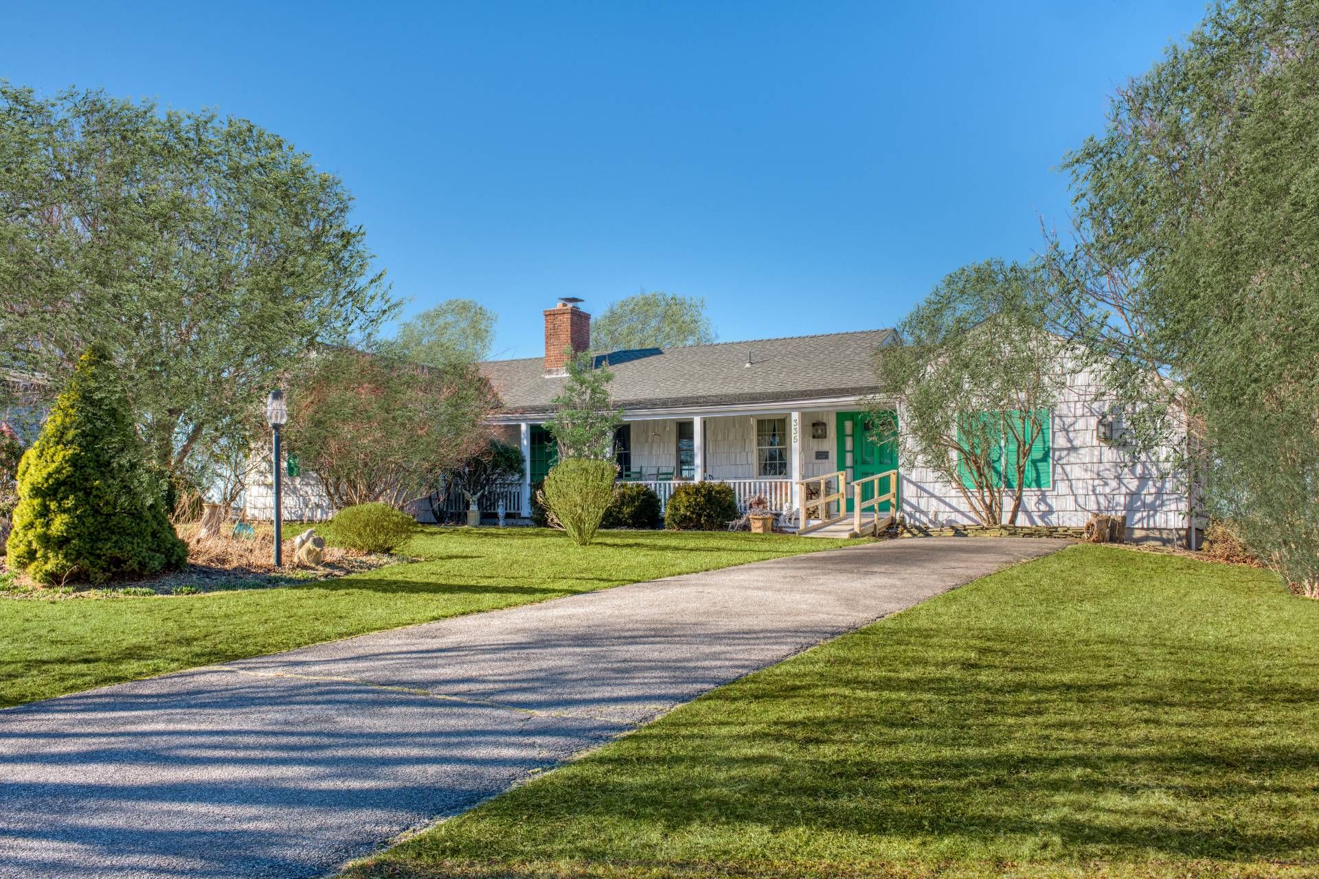 335 Sound View Road Orient, NY 11957 - Photo 6 of 22 a front view of a house with a yard and garage