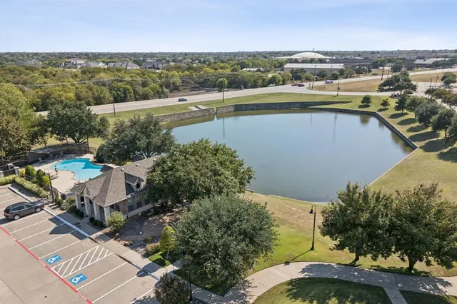 an aerial view of a city with lots of residential buildings ocean and mountain view in back