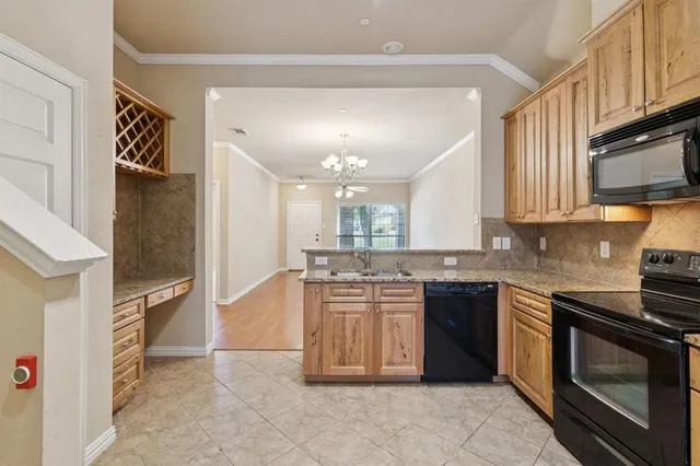 a kitchen with stainless steel appliances granite countertop a stove top oven a sink dishwasher and a refrigerator