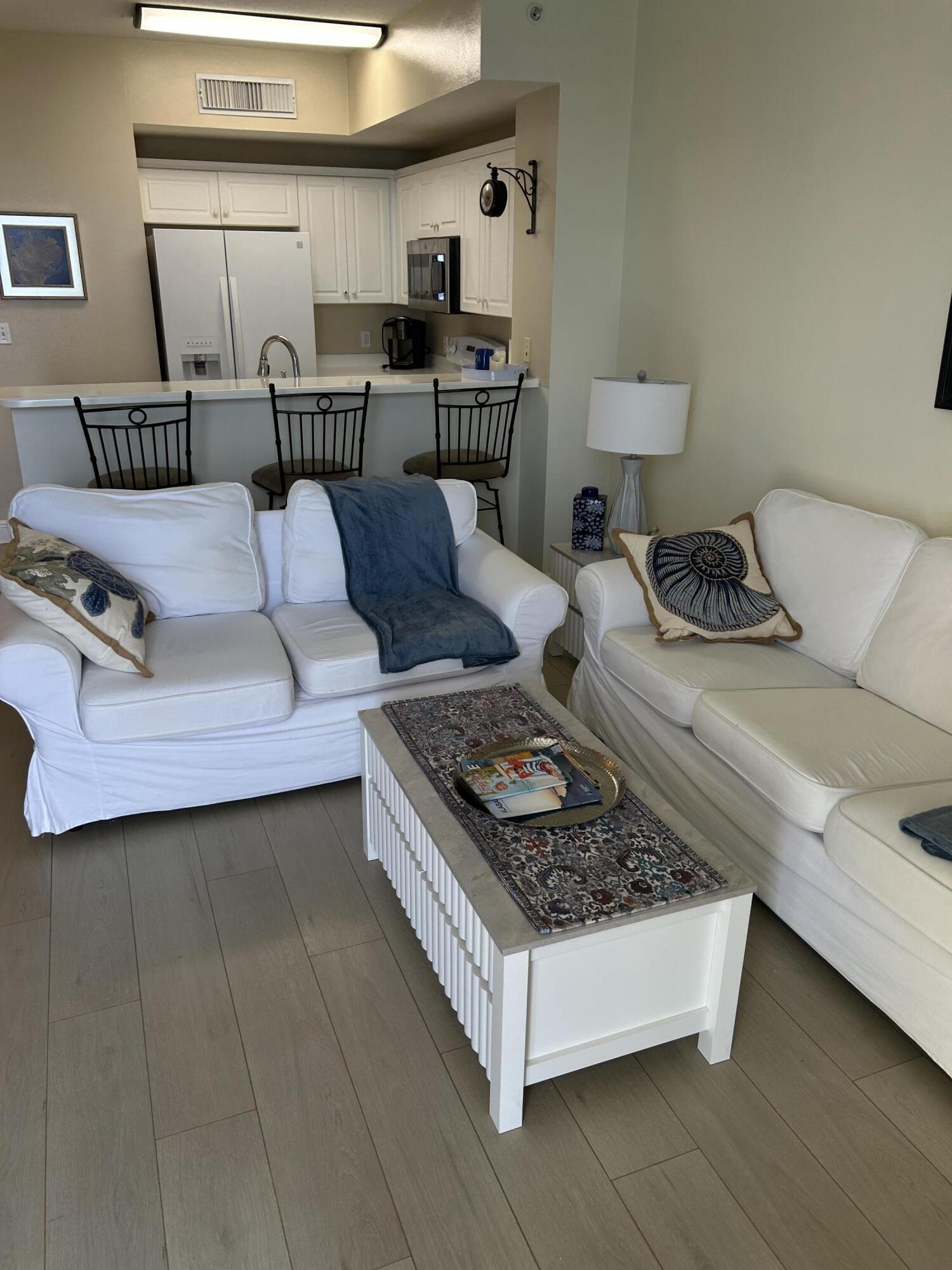17757 Front Beach Road, Unit 2204D Panama City Beach, FL 32413 - Photo 11 of 32 a living room with furniture and a rug