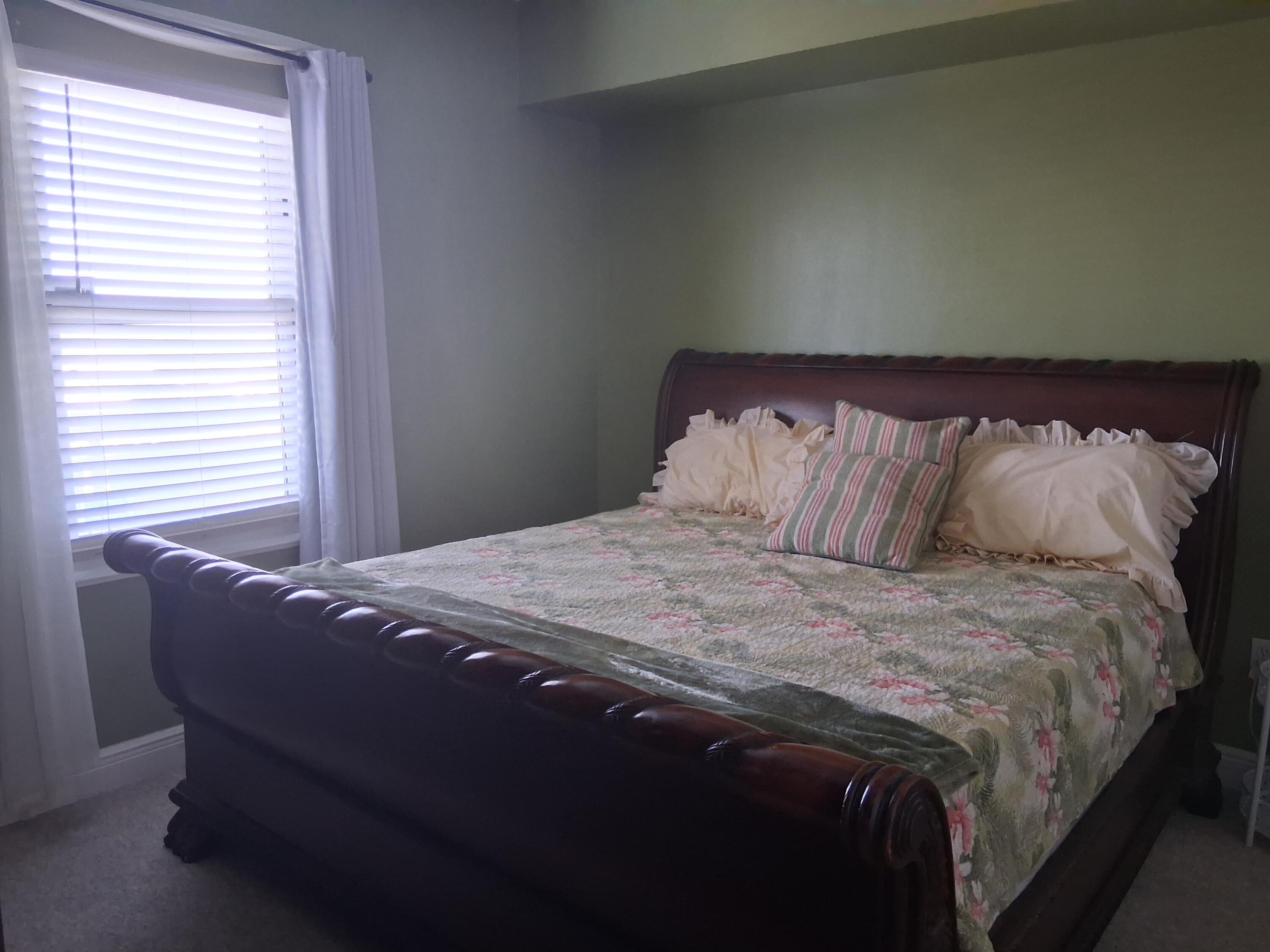17757 Front Beach Road, Unit 2204D Panama City Beach, FL 32413 - Photo 20 of 32 a bed sitting in a bedroom next to a window
