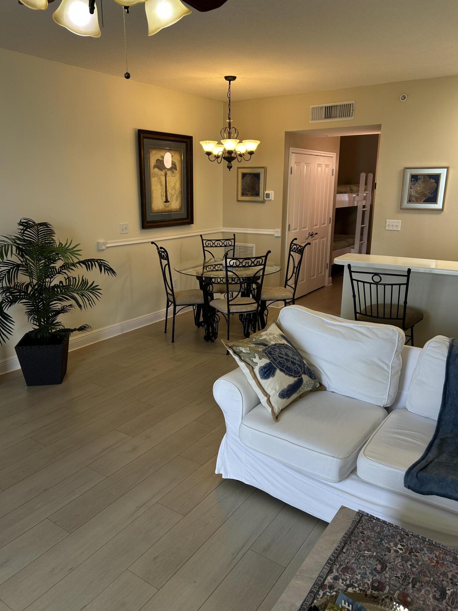 17757 Front Beach Road, Unit 2204D Panama City Beach, FL 32413 - Photo 5 of 32 a living room with furniture and wooden floor