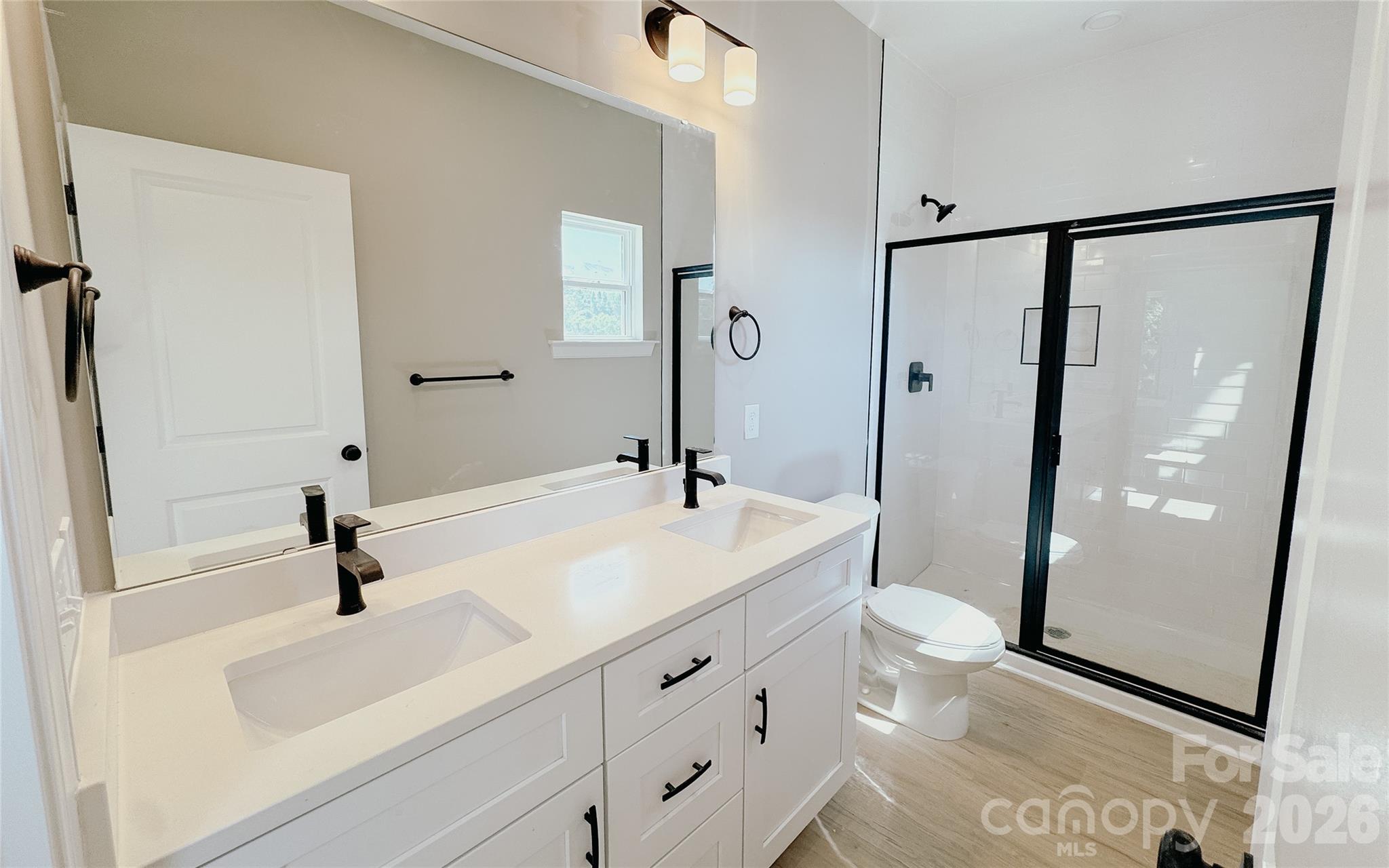1455 West Ridge Road Salisbury, NC 28147 - Photo 16 of 26 a bathroom with a sink a mirror and shower