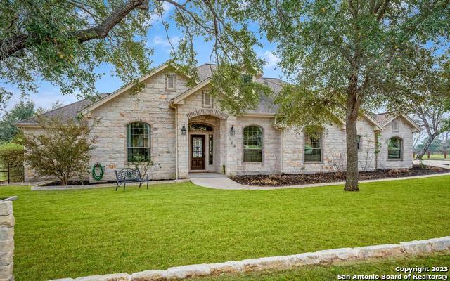 104 Rosewood Drive La Vernia, TX 78121 - Photo 1 of 1 a front view of a house with a yard and garage