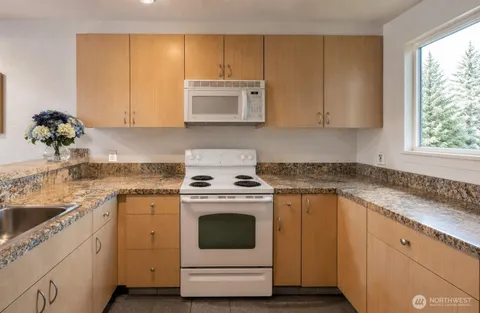 a kitchen with a sink stove and cabinets