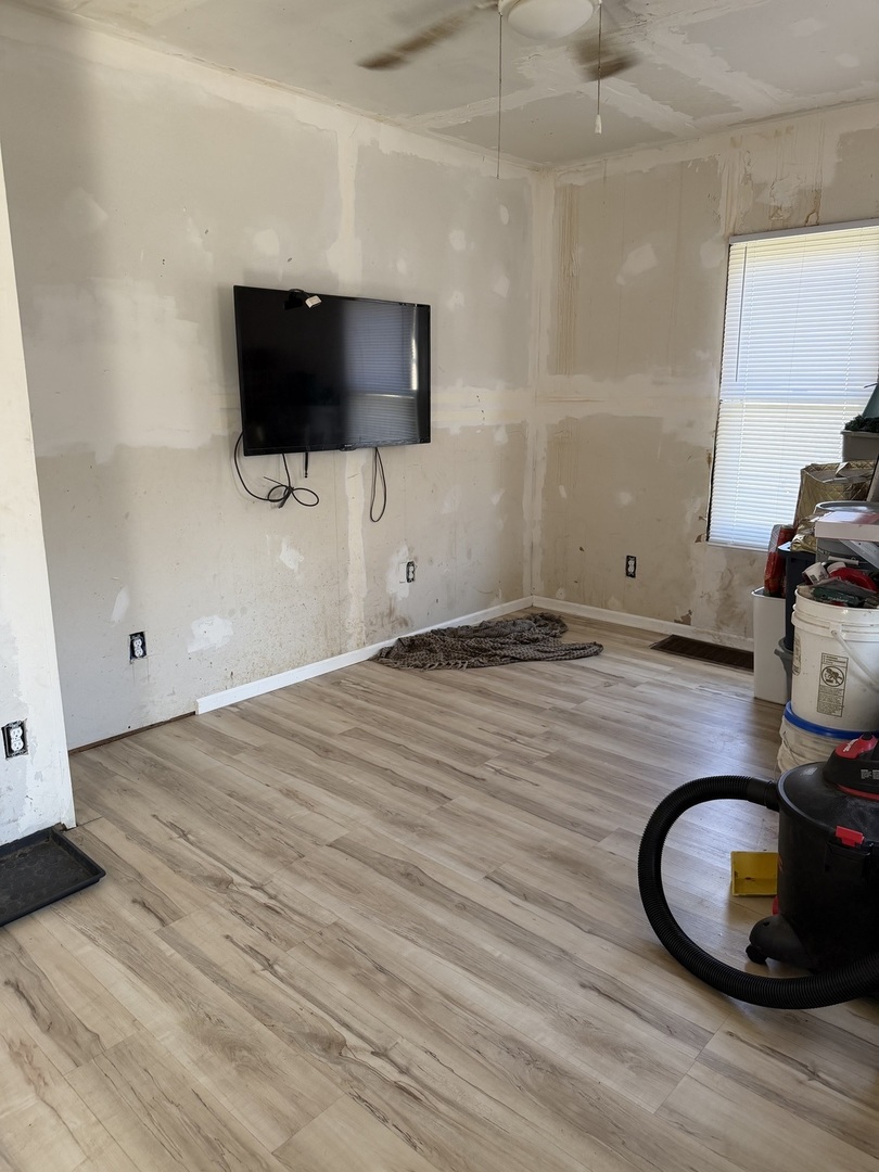 229 North 6th Avenue Kankakee, IL 60901 - Photo 7 of 16 a room with wooden floor and flat screen tv
