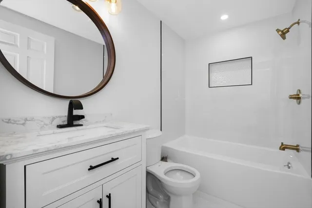 a bathroom with a sink a toilet and a bathtub