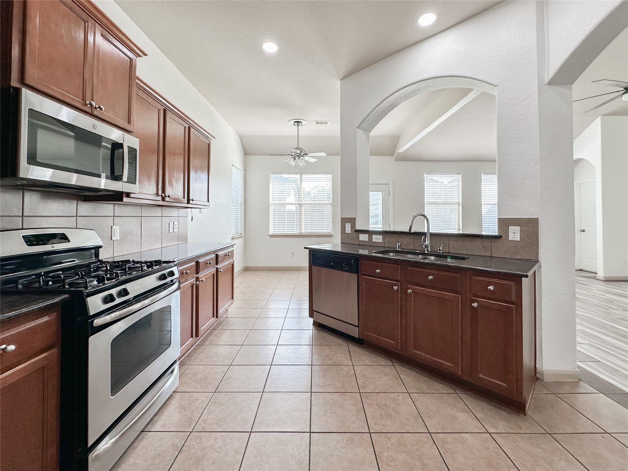 20319 Little Wing Drive Spring, TX 77388 - Photo 27 of 49 a large kitchen with stainless steel appliances granite countertop a stove and a sink