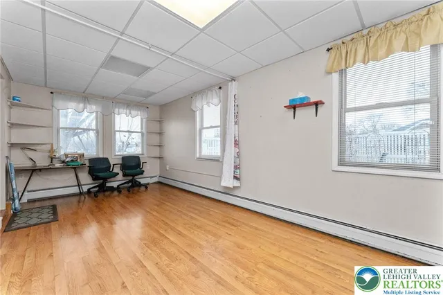 a view of a room with gym equipment and windows
