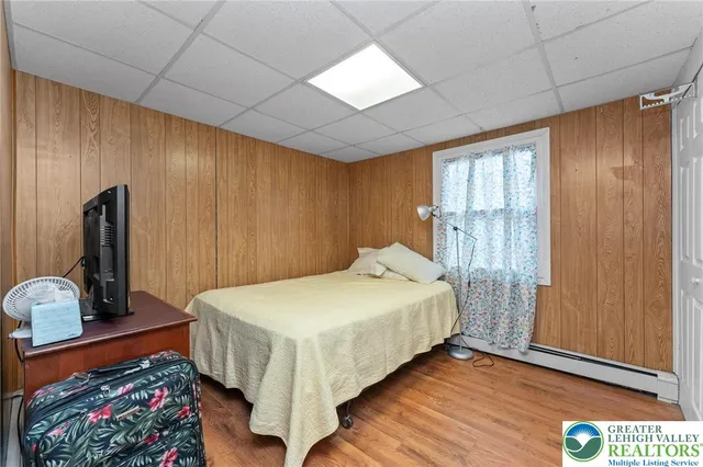 a bed sitting in a spacious bedroom next to a window