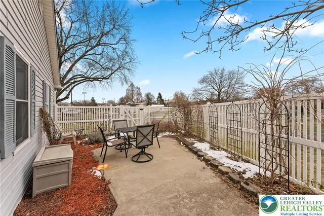 a view of a patio with a table and chairs