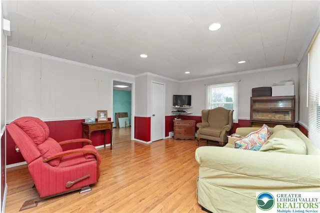 a living room with furniture kitchen view and a couch
