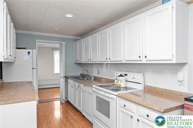 a kitchen with stainless steel appliances granite countertop a sink and cabinets