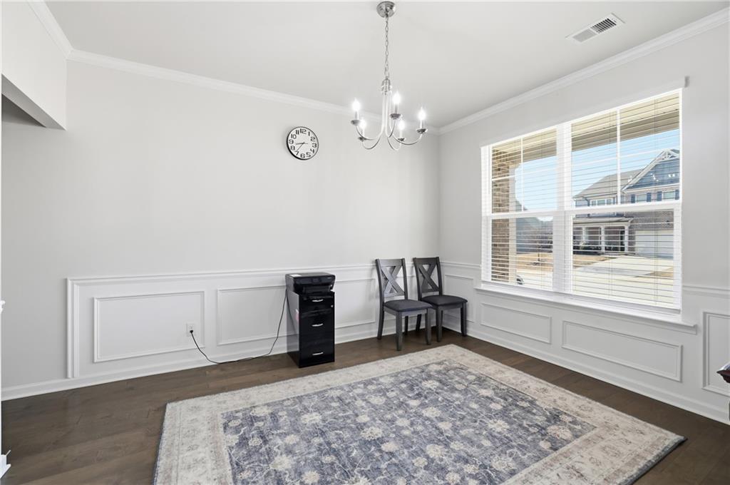 175 Paxton Lane Jefferson, GA 30549 - Photo 14 of 39 a spacious bedroom with a bed and a chandelier