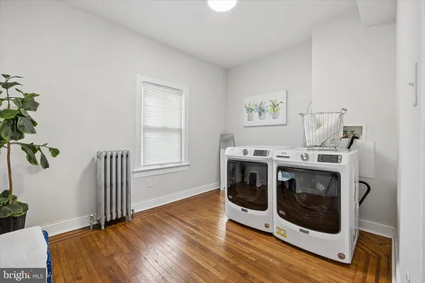a kitchen with cabinets and wooden floor