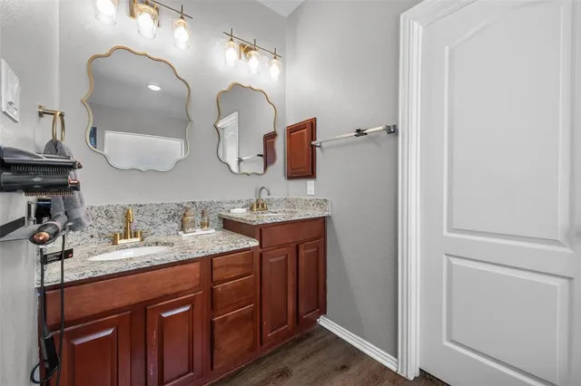 a bathroom with a double vanity sink and a mirror