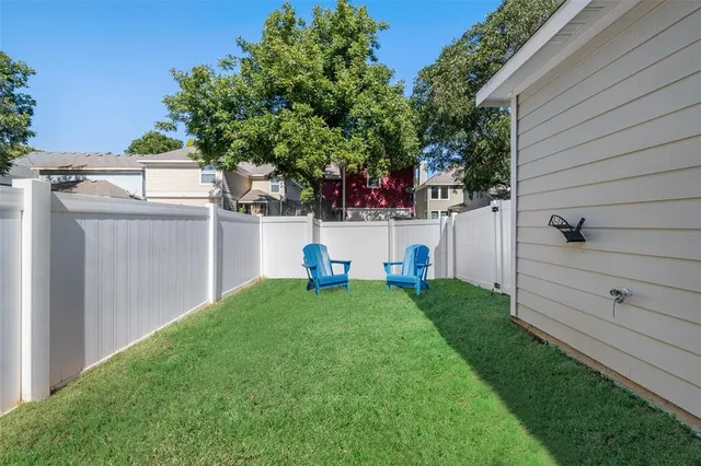 a view of backyard with a small cabin and a chair