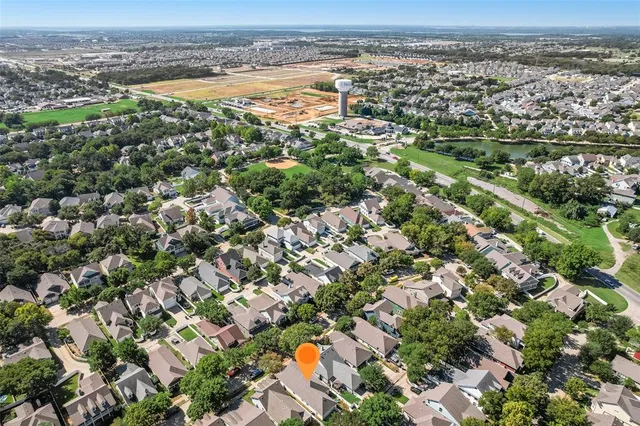 an aerial view of beach and residential houses with outdoor space
