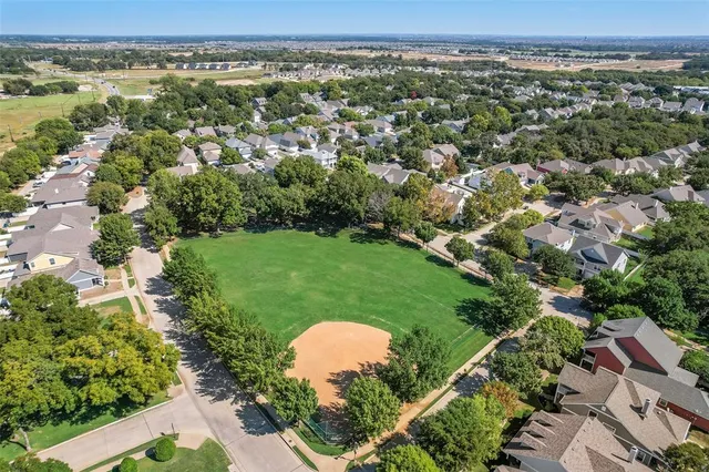 an aerial view of a house with a yard and lake view