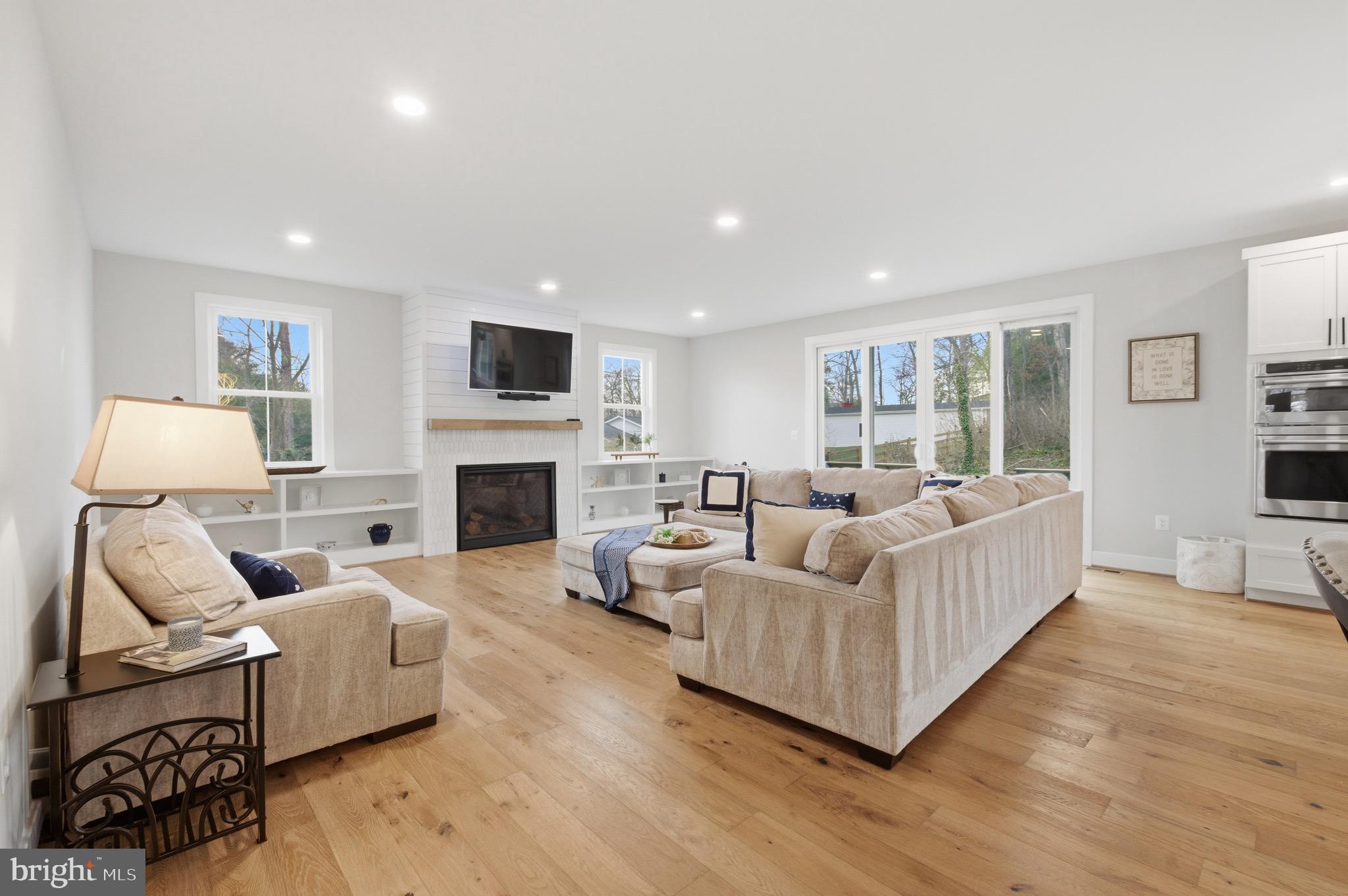 1304 Gahant Road Alexandria, VA 22308 - Photo 14 of 56 Family room with gas fireplace and build-in shelve