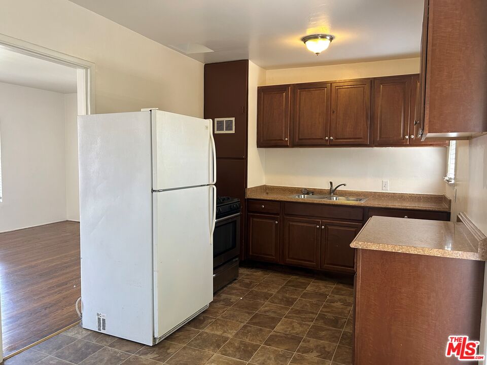 4107 Wade Street, Unit H Los Angeles, CA 90066 - Photo 7 of 16 a kitchen with a refrigerator sink and cabinets