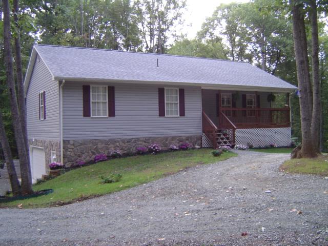 235 Deep Woods Road Hardy, VA 24101 - Photo 1 of 10 a front view of a house with garden