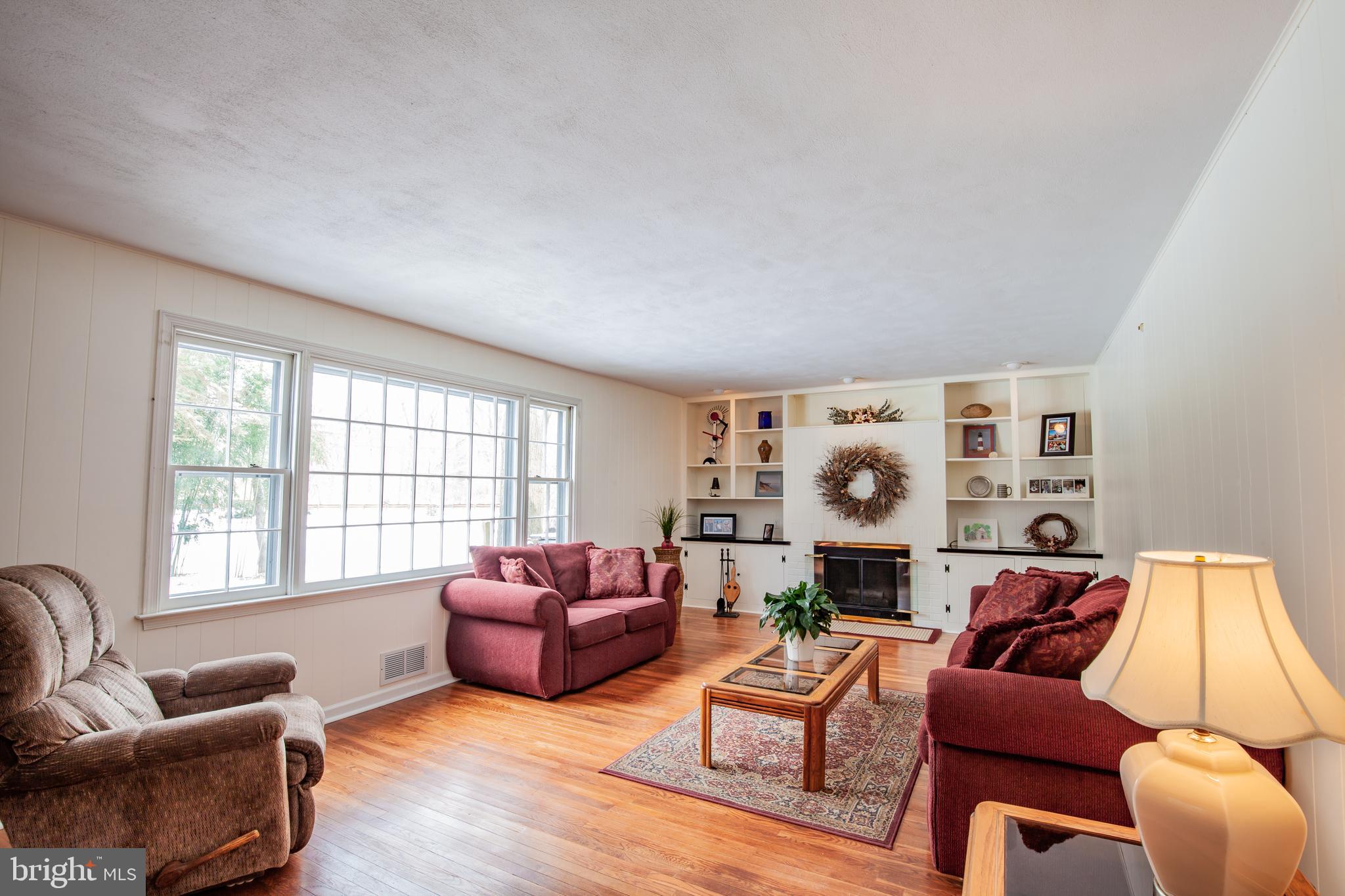 771 Richards Road Wayne, PA 19087 - Photo 14 of 41 a living room with furniture a fireplace and a large window
