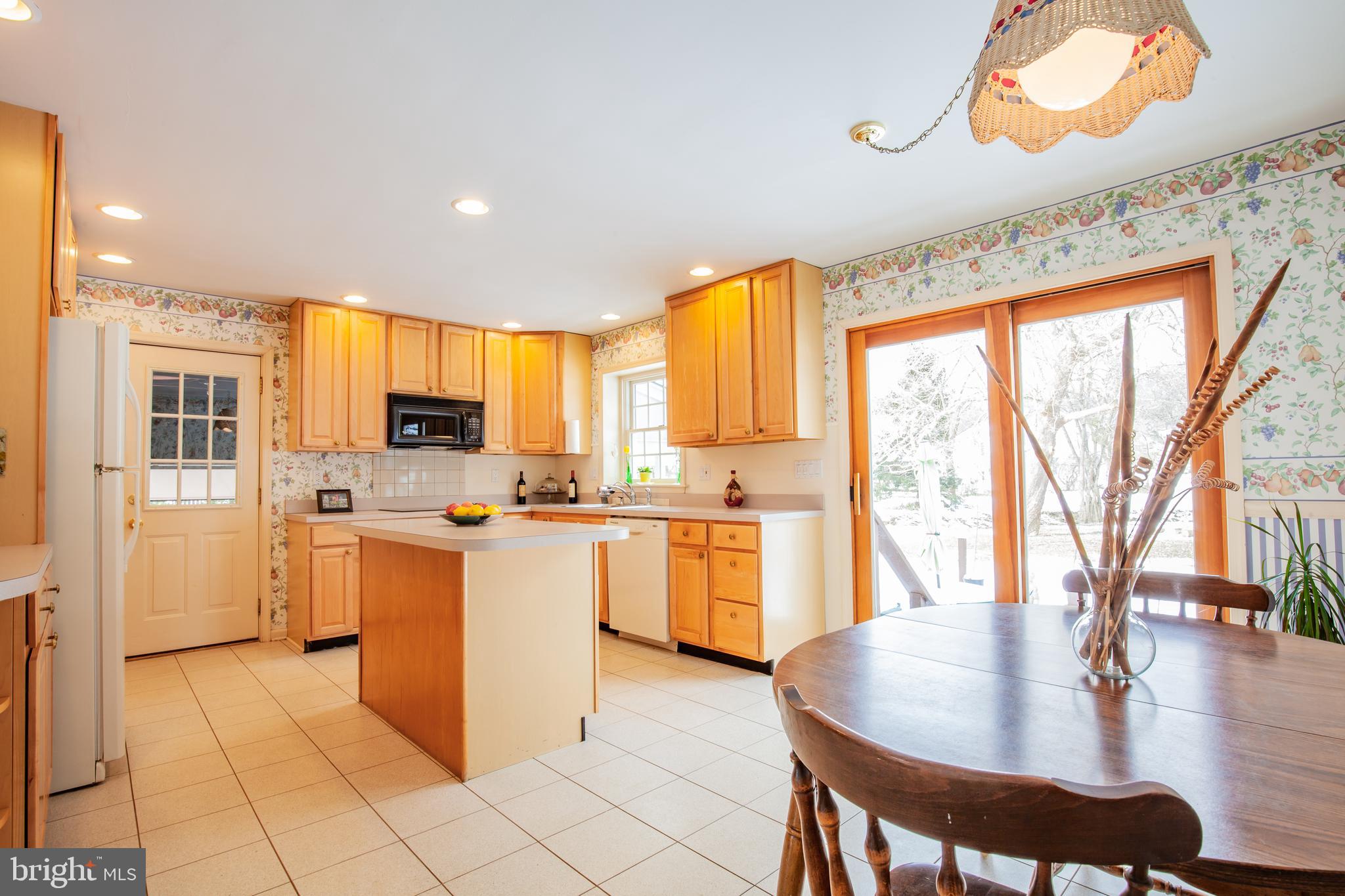 771 Richards Road Wayne, PA 19087 - Photo 15 of 41 a kitchen with a table chairs microwave and cabinets