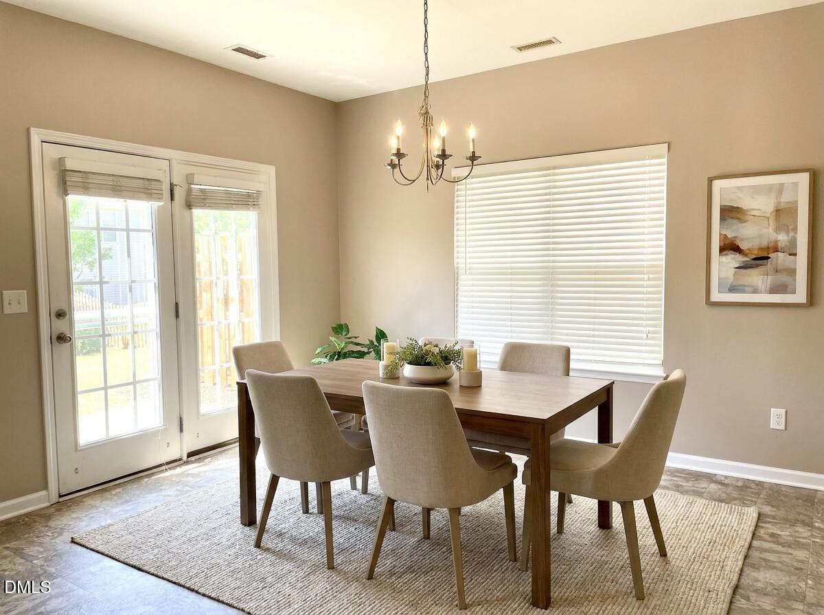 3531 Oneonta Avenue Raleigh, NC 27604 - Photo 6 of 22 a view of a dining room with furniture wooden floor and a chandelier